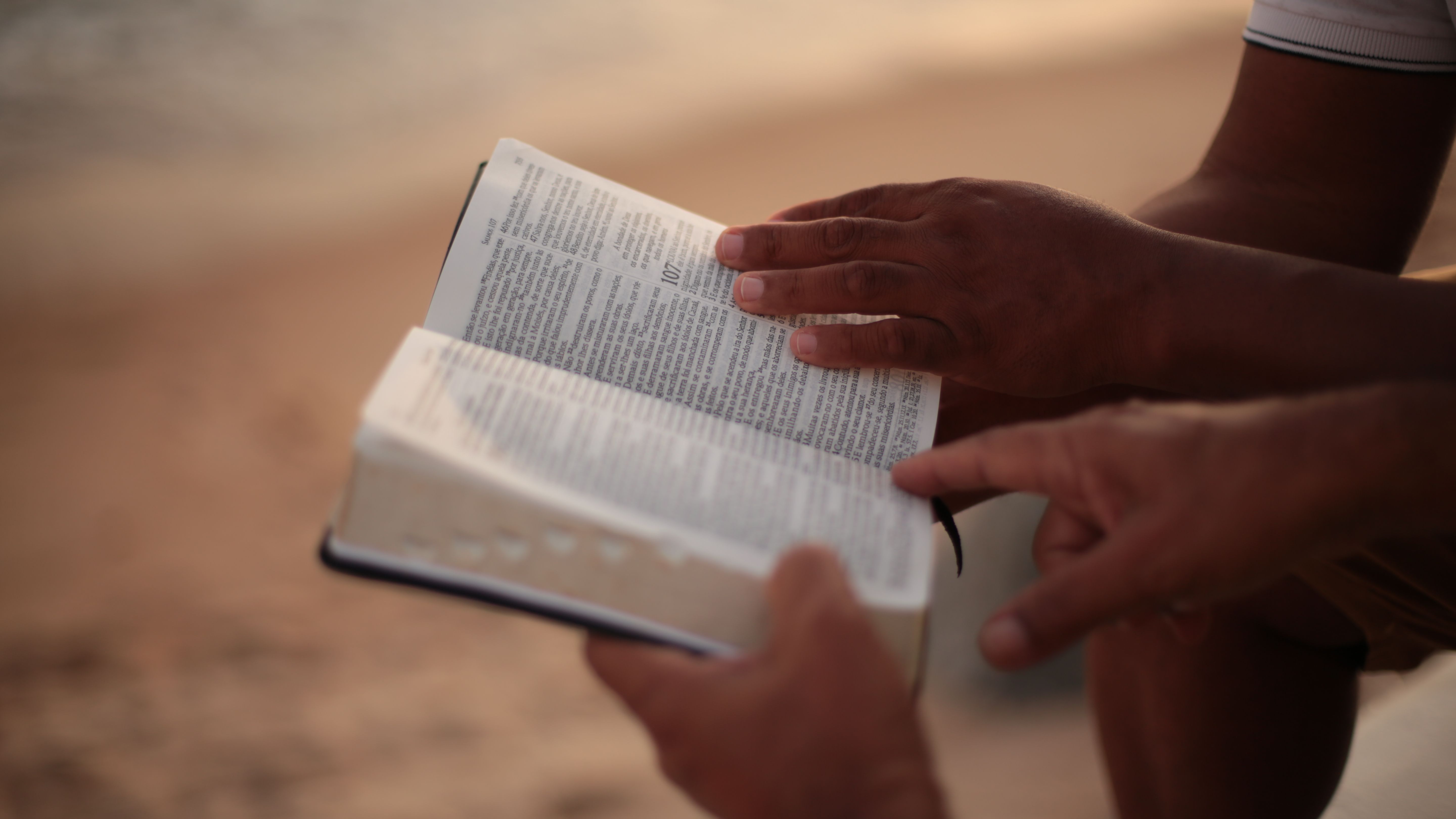 Pointing at open page of a Bible